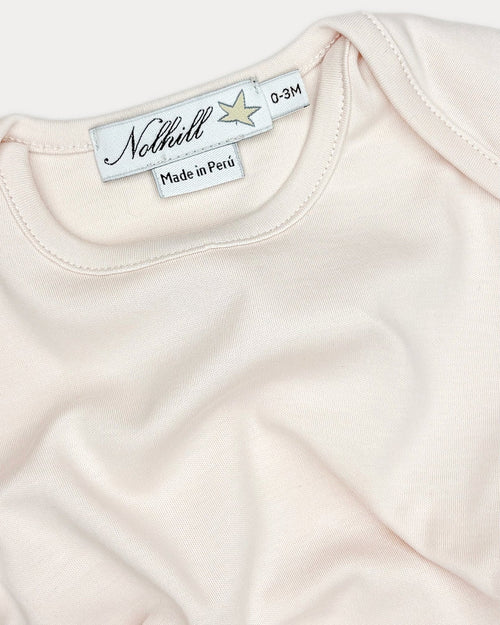 Oatmeal,  Close-up of lap-neck design with expandable shoulders on Essential bodysuit