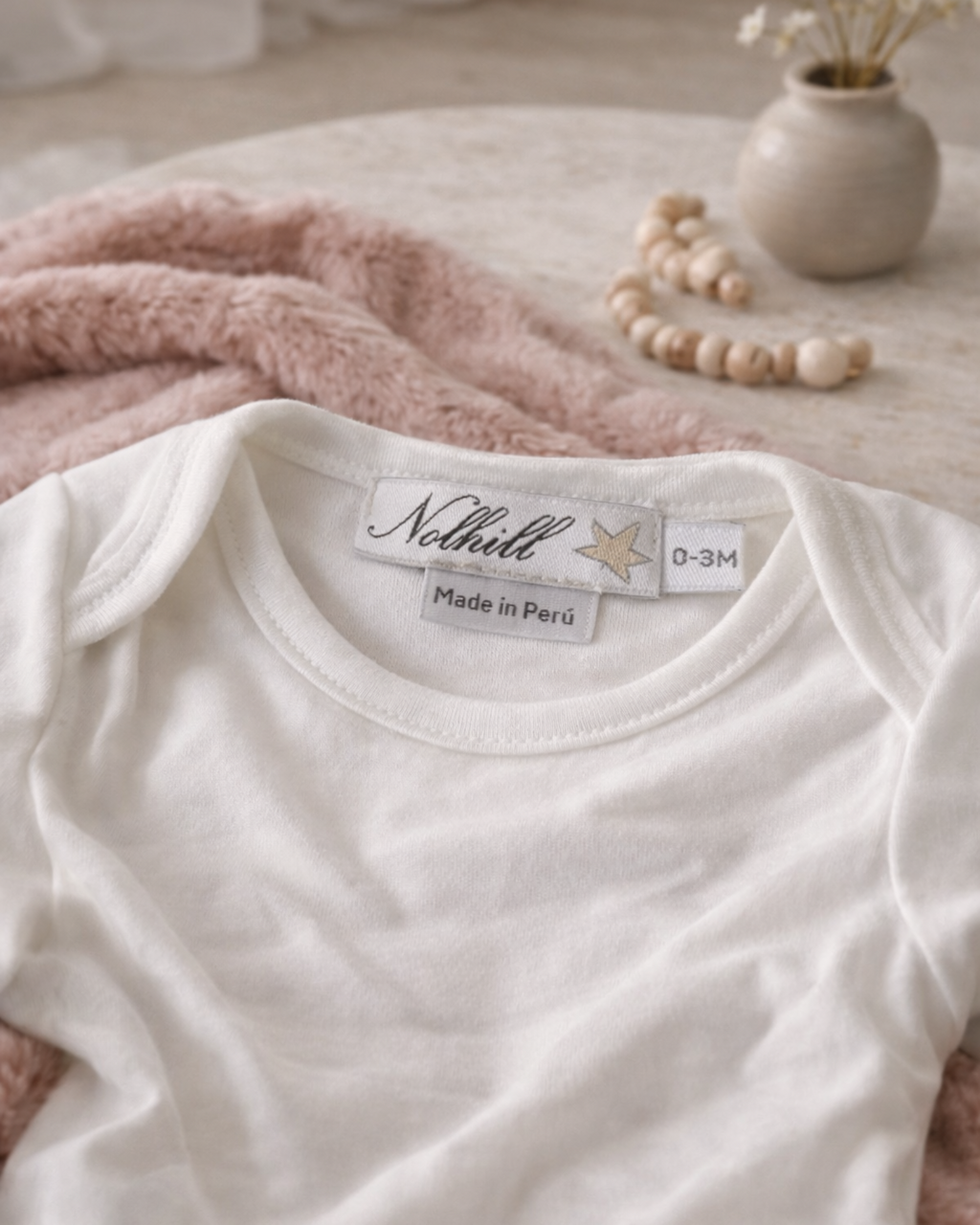 carousel, Lifestyle image of Nolhill Essential Pima cotton bodysuit for newborns