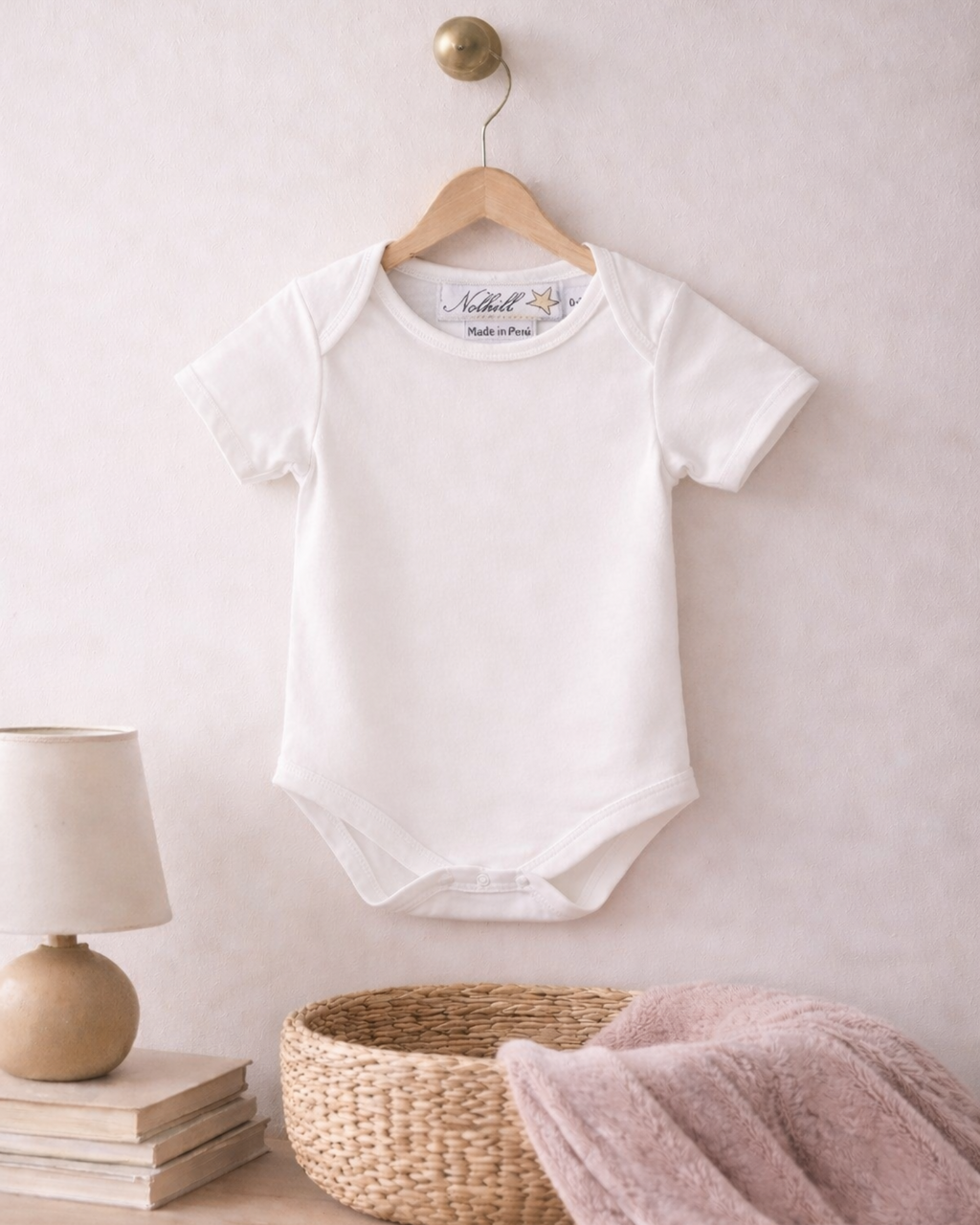 White, Lifestyle image of Nolhill Essential Pima cotton bodysuit for newborns