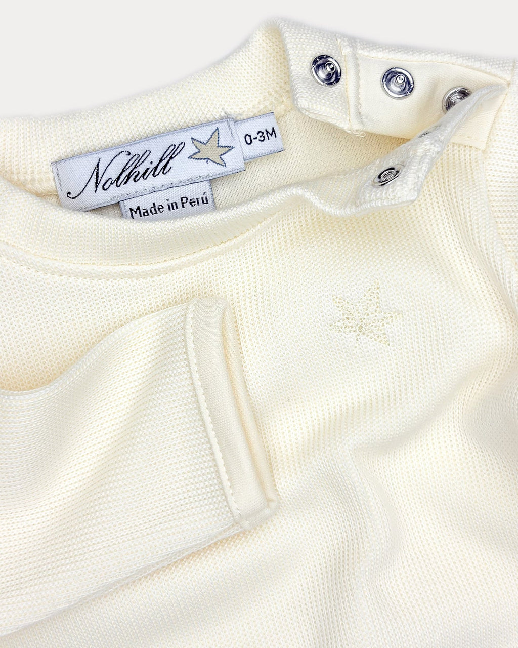 Bianca-, White, Oatmeal, Close-up of tonal embroidery and Pima Piqué texture on Freya layette set