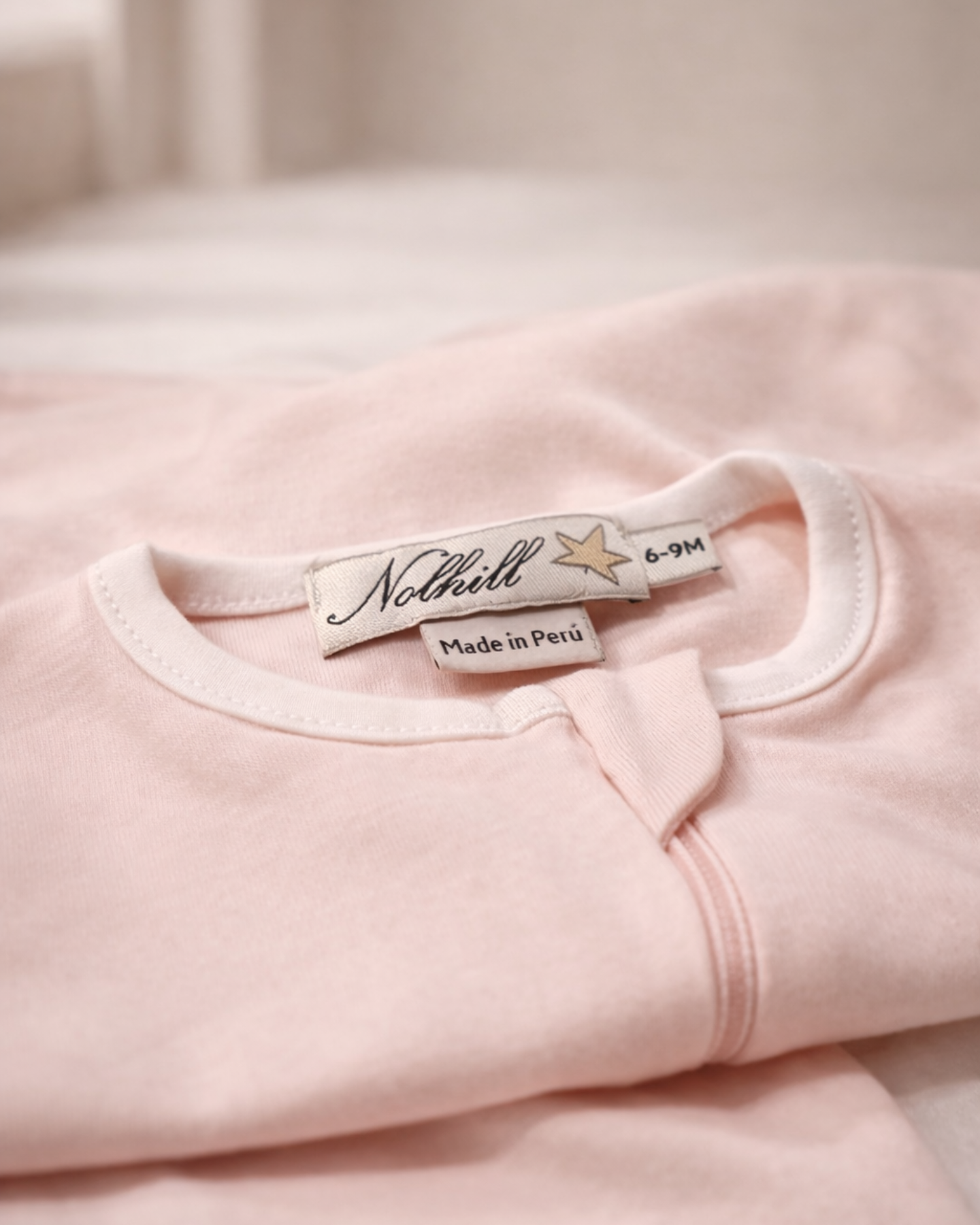 Carousel, Lifestyle image of Nolhill Lina footless romper for newborns pima cotton