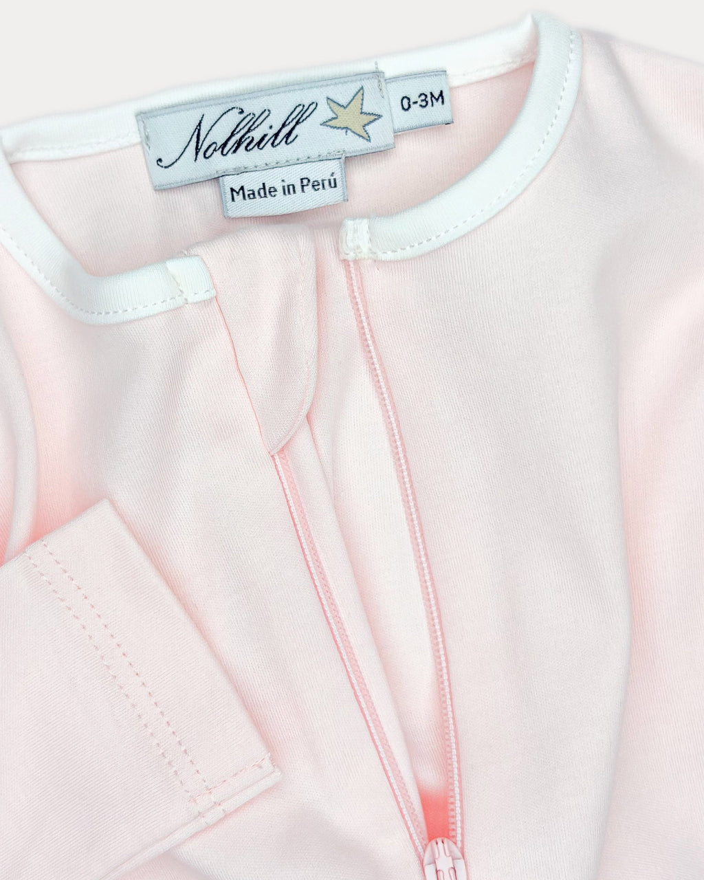Rose, White, Oatmeal, Close-up of asymmetric hidden zipper and contrast collar on Lina footless romper