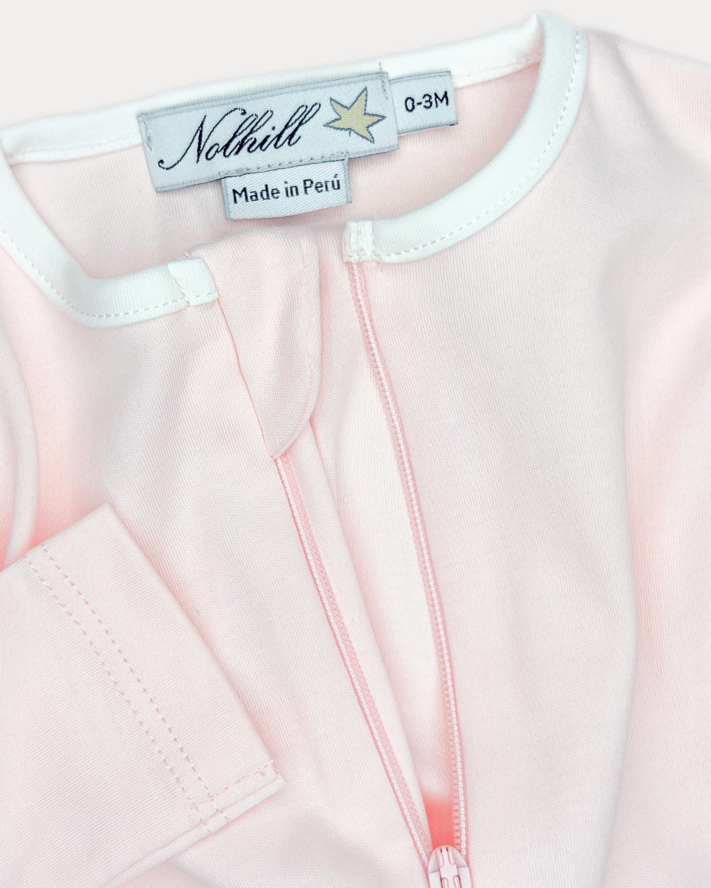 Rose, White, Oatmeal, Close-up of asymmetric hidden zipper and contrast collar on Lina footless romper