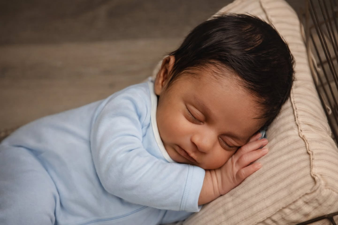 Luxury newborn portrait by Angi Carman featuring the Nolhill Nicolas footless romper in soft heather Pima cotton.