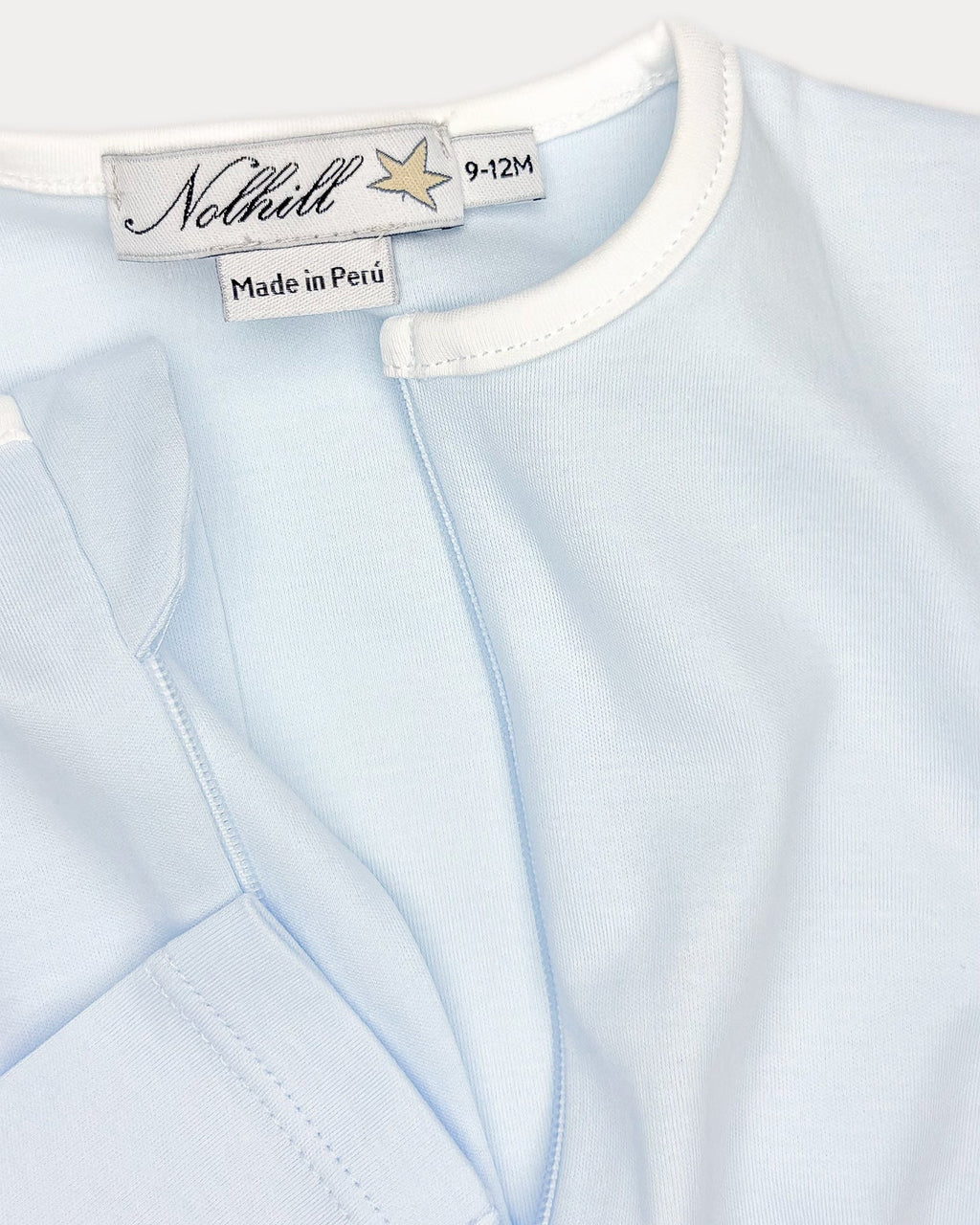 Arctic blue, White, Oatmeal, Close-up of asymmetric hidden zipper and contrast collar on Nicolas footless romper