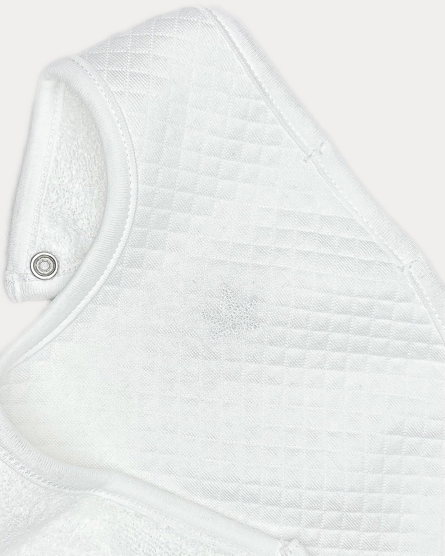 white, Close-up of quilted texture and tonal embroidery on Remy baby bib