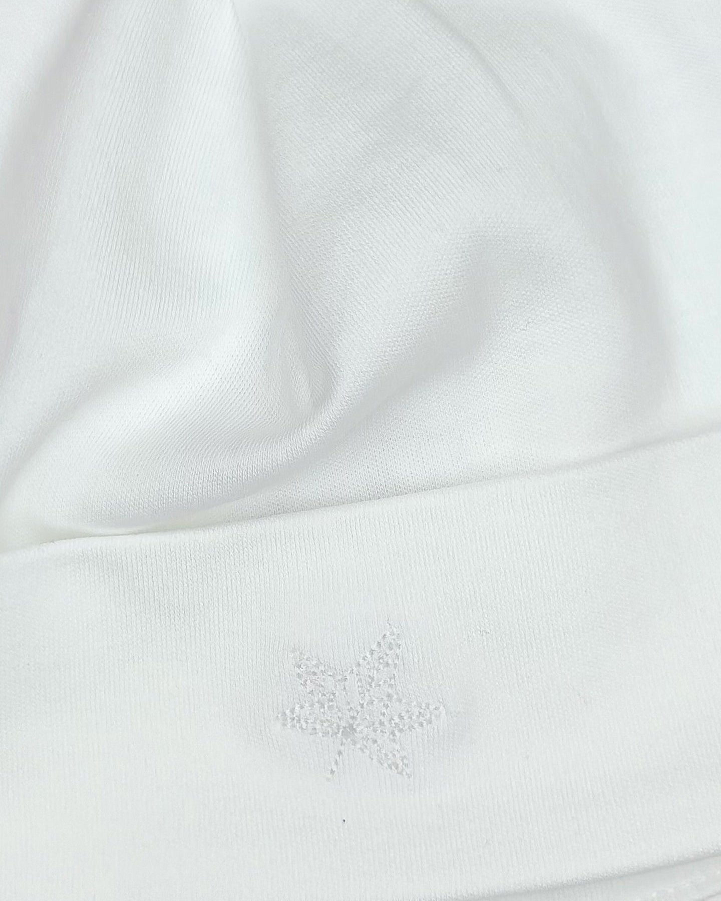 Whites, Close-up of tonal embroidery detail on Valentine newborn beanie